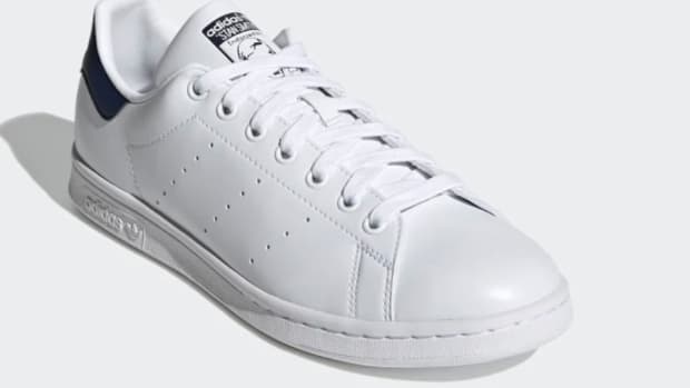 White and navy Adidas shoe.
